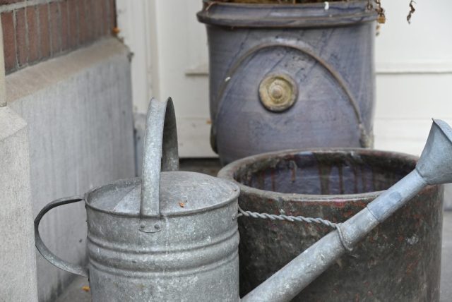 Photo of a watering can in front of other objects